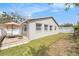Private backyard featuring a patio with an umbrella table, partial fence and lush lawn at 2519 Southern Oak Cir, Clearwater, FL 33764
