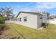 Spacious backyard showcasing partial privacy fence with green grass and ample space at 2519 Southern Oak Cir, Clearwater, FL 33764