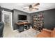 Well-appointed bar room featuring custom shelving, wine cooler, large tv and neutral gray walls at 2519 Southern Oak Cir, Clearwater, FL 33764