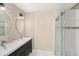 Stylish bathroom featuring dual sinks and a glass-enclosed walk-in shower at 2519 Southern Oak Cir, Clearwater, FL 33764