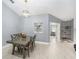 Cozy dining area with a modern chandelier and easy access to the living room at 2519 Southern Oak Cir, Clearwater, FL 33764