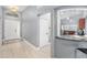 Inviting entryway with wood-look floors that leads to the kitchen featuring a bar counter at 2519 Southern Oak Cir, Clearwater, FL 33764