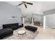 Spacious living room with an open floor plan and stylish dark furniture at 2519 Southern Oak Cir, Clearwater, FL 33764