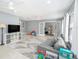 Large living room boasts natural light from ample windows and features wood-look floors at 2519 Southern Oak Cir, Clearwater, FL 33764