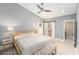 Large main bedroom with a tray ceiling, a barn door closet, and neutral paint at 2519 Southern Oak Cir, Clearwater, FL 33764