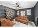 Cozy office with a sofa, a built-in bar, and a ceiling fan at 2519 Southern Oak Cir, Clearwater, FL 33764