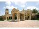 Elegant clubhouse exterior with portico, towers, stucco finish, and manicured landscaping at 254 Padova Way, North Venice, FL 34275