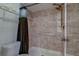 A accessible shower/toilet combo with handrails and shelving unit at 2847 Rampart Cir, Clearwater, FL 33761