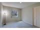 A bright room with grey tile flooring with a closet and a window to the outside at 2847 Rampart Cir, Clearwater, FL 33761