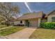Charming single-story home with well-maintained landscaping and attached garage on a sunny day at 2847 Rampart Cir, Clearwater, FL 33761