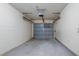 Garage featuring a gray garage door, cement walls, and sealed concrete floor at 2847 Rampart Cir, Clearwater, FL 33761