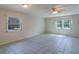 Bright and airy living room featuring large windows, neutral paint, and tile flooring for easy maintenance at 2847 Rampart Cir, Clearwater, FL 33761