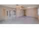 Large living area with tile flooring, sliding glass doors to the backyard and view to the kitchen at 2847 Rampart Cir, Clearwater, FL 33761