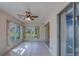 Bright sun room featuring sliding glass doors and windows offering backyard views and a ceiling fan at 2847 Rampart Cir, Clearwater, FL 33761