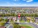 Panoramic aerial view showcasing a residential community with homes, lakes, and lush green landscapes at 31123 Stone Arch Ave, Wesley Chapel, FL 33545