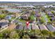 Aerial view of a residential area featuring single-Gathering homes, surrounded by lush greenery and lakes at 31123 Stone Arch Ave, Wesley Chapel, FL 33545