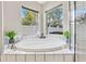 Elegant bathroom showcasing a soaking tub, separate shower, and stylish tile work at 31123 Stone Arch Ave, Wesley Chapel, FL 33545