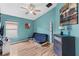 Inviting bedroom with a modern color scheme, hardwood floors, and cozy seating at 31123 Stone Arch Ave, Wesley Chapel, FL 33545