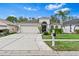 Charming single-story home with a well-manicured lawn, two-car garage, and inviting front entrance at 31123 Stone Arch Ave, Wesley Chapel, FL 33545