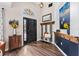 Inviting foyer with hardwood flooring, decorative accents, and a statement front door at 31123 Stone Arch Ave, Wesley Chapel, FL 33545