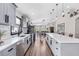 Spacious kitchen featuring grey cabinets, a large island, and seamless flow to the dining area at 31123 Stone Arch Ave, Wesley Chapel, FL 33545
