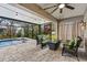Relaxing enclosed lanai with a hot tub and cozy wicker furniture for outdoor enjoyment at 31123 Stone Arch Ave, Wesley Chapel, FL 33545