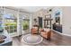 Cozy living room with large windows, hardwood floors, and direct access to the front entry at 31123 Stone Arch Ave, Wesley Chapel, FL 33545