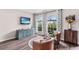 Cozy living room featuring large windows, comfortable seating, and stylish decor at 31123 Stone Arch Ave, Wesley Chapel, FL 33545