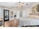 Spacious main bedroom with wood floors, multiple closets, and access to a private outdoor space at 31123 Stone Arch Ave, Wesley Chapel, FL 33545