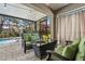 Inviting outdoor patio featuring comfortable wicker furniture with green cushions and a charming fire pit table at 31123 Stone Arch Ave, Wesley Chapel, FL 33545
