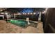 Gorgeous pool with basketball hoop, fountains, and patio heaters, surrounded by a screened enclosure and stone pavers at 31123 Stone Arch Ave, Wesley Chapel, FL 33545