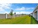 Large backyard featuring newly installed landscaping, grass and privacy fence at 32335 Wetland Bird Vw, San Antonio, FL 33576