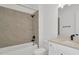 Bathroom featuring modern tiled shower, vanity with sink and dark fixtures at 32335 Wetland Bird Vw, San Antonio, FL 33576