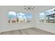 Dining room with wood floors, large windows, and modern lighting at 32335 Wetland Bird Vw, San Antonio, FL 33576