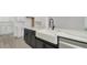 Close up of modern kitchen featuring a large center island, farmhouse sink, and stainless steel appliances at 32335 Wetland Bird Vw, San Antonio, FL 33576