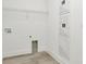 Bright laundry room with overhead shelving, modern flooring and new washer/dryer hookups at 32335 Wetland Bird Vw, San Antonio, FL 33576