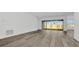 Spacious living room featuring wood floors, and sliding glass doors leading to an outdoor space at 32335 Wetland Bird Vw, San Antonio, FL 33576