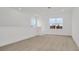 Spacious loft area featuring carpet flooring, natural light, and neutral walls at 32335 Wetland Bird Vw, San Antonio, FL 33576
