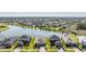 Aerial view showcasing a serene lake, lush landscaping, and well-maintained homes in the community at 33899 Astoria Cir, Wesley Chapel, FL 33545
