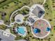 Aerial view of a park with walking paths, picnic pavilions, a pool, and a playground at 33899 Astoria Cir, Wesley Chapel, FL 33545