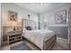 Cozy bedroom featuring a tufted headboard, a neutral palette, and wood-look tile flooring at 33899 Astoria Cir, Wesley Chapel, FL 33545