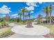 Beautiful Promenade Park sign and statue surrounded by lush landscaping and palm trees, enhancing the community's charm at 33899 Astoria Cir, Wesley Chapel, FL 33545