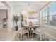 Bright breakfast nook features a round table, decorative chandelier, and sun-filled window at 33899 Astoria Cir, Wesley Chapel, FL 33545