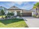Charming single-Gathering home with manicured lawn, elegant landscaping, and a two-car garage at 33899 Astoria Cir, Wesley Chapel, FL 33545