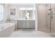 Light and airy main bathroom with dual vanity, soaking tub, and glass shower at 33899 Astoria Cir, Wesley Chapel, FL 33545