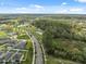 Wide aerial shot of the community showcasing homes, ponds, green spaces, and tree-lined streets at 35592 Stella Vast Dr, Zephyrhills, FL 33541