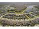 Stunning aerial view of a residential community featuring homes and lush landscaping near tranquil lakes and nature preserve at 3991 Mellon Dr, Odessa, FL 33556