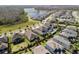 An aerial view reveals the community's blend of modern homes, lush green spaces, and a tranquil lake at 3991 Mellon Dr, Odessa, FL 33556
