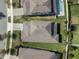An aerial view displays a well-manicured lawn, a pool, and neatly arranged residences in a suburban neighborhood at 3991 Mellon Dr, Odessa, FL 33556