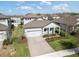 Aerial view of a single-story home with a manicured lawn, paved driveway, and well-kept landscaping at 3991 Mellon Dr, Odessa, FL 33556